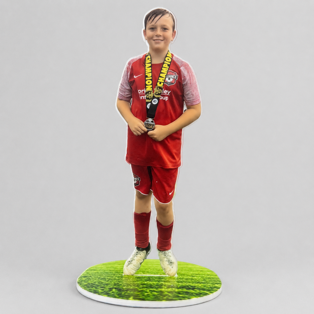 Personalized sports action statue on a flat grass-print acrylic base