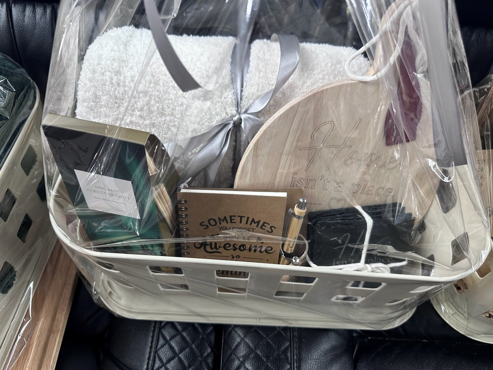 Wrapped personalized closing gift basket with white blanket